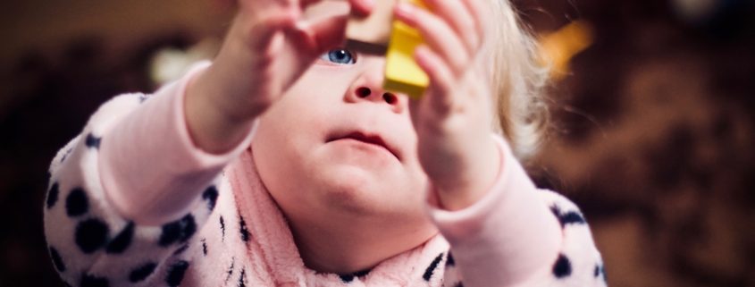 A young child plays with building blocks.